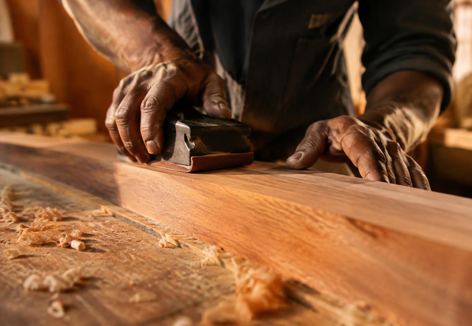 Craftsman sanding teak